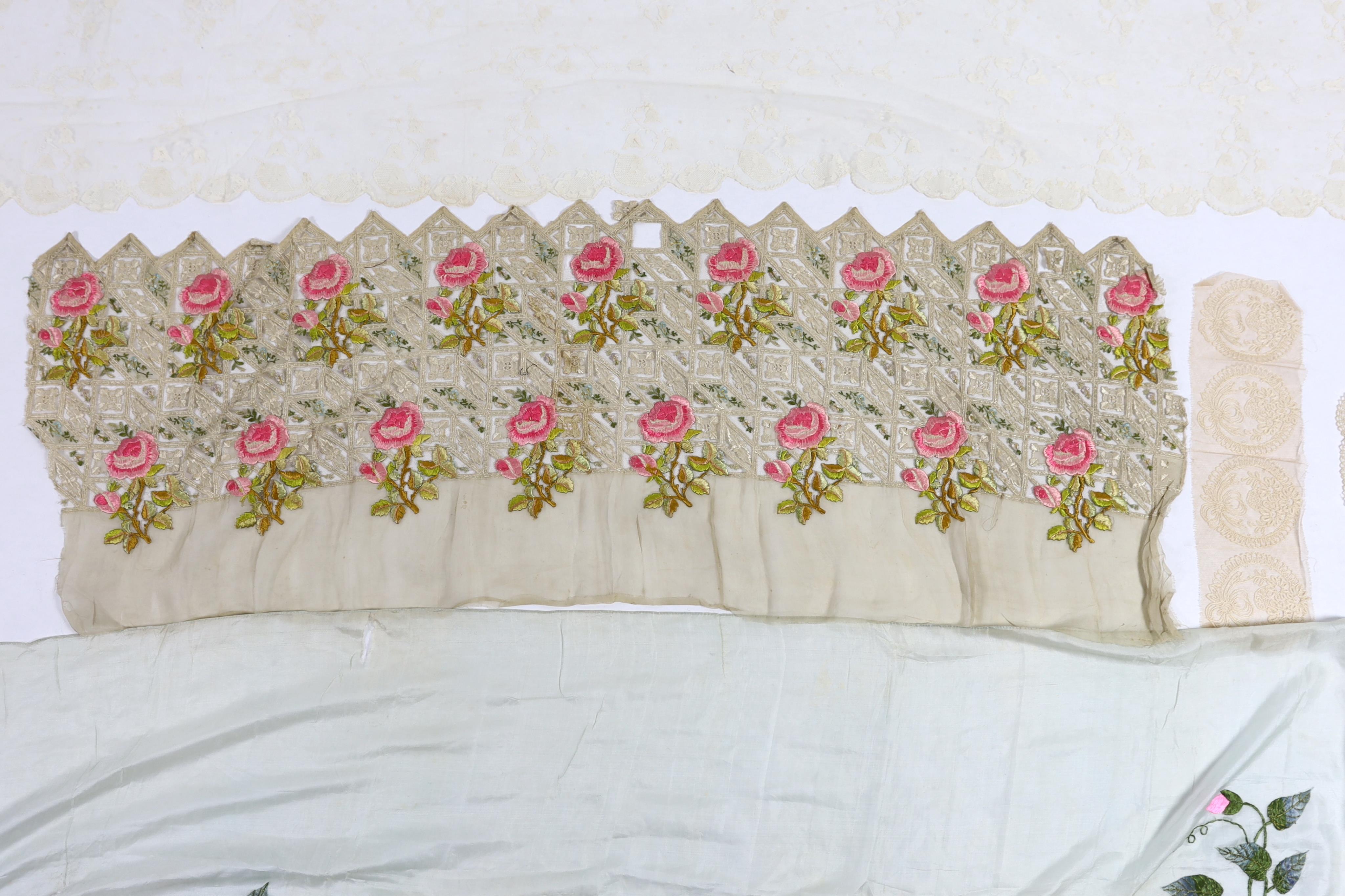 An early 20th century fine spun silk embroidered and fringed pelmet, a lace and polychrome embroidered border, possibly a panel to a dress, a needle run lace stole, a Normandy lace border to a circular mat, a bobbin lace